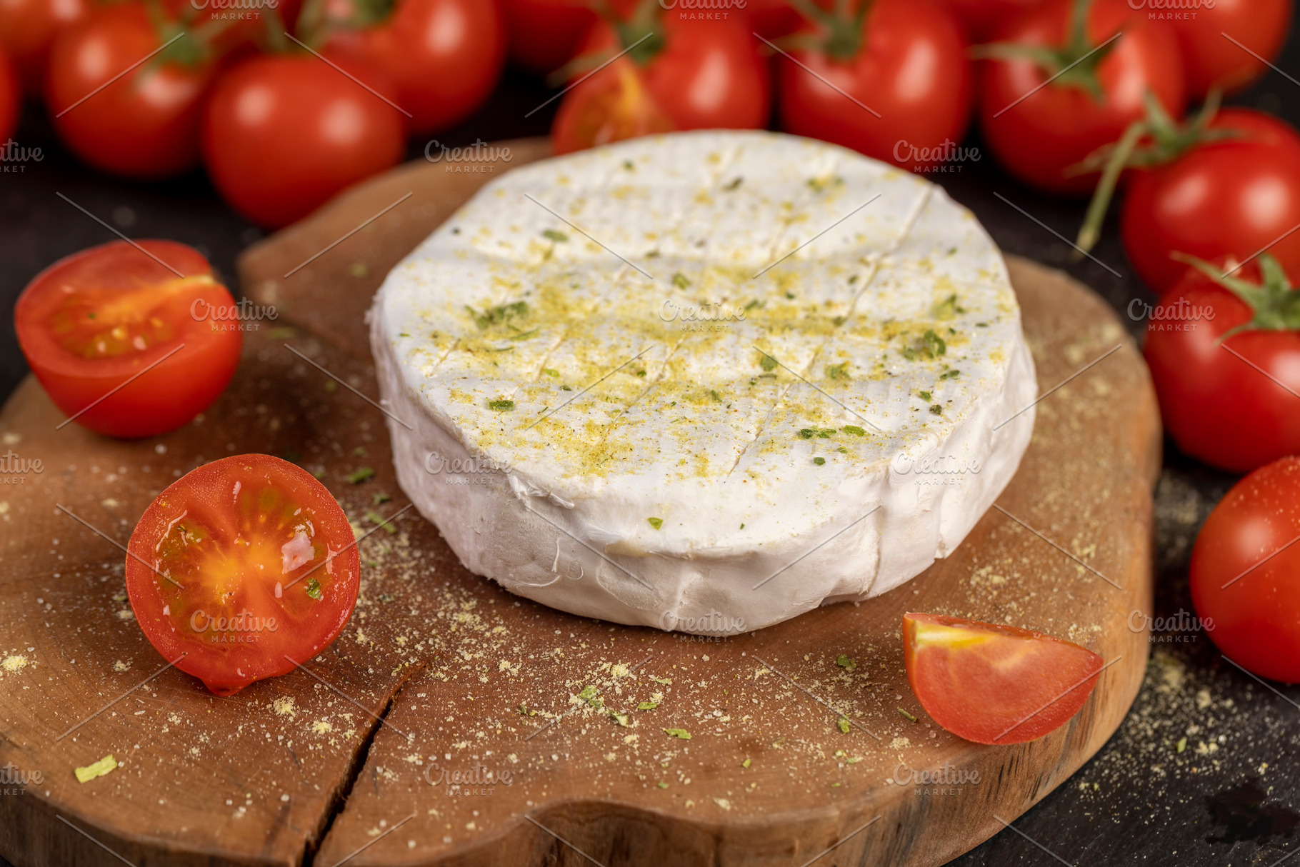a piece of ripe soft cheese and some small red round tomatoes, a Photo by rsoollAI