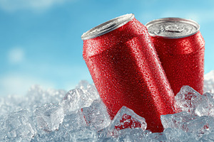 Red soda cans in ice refreshing summ, a Photo by Pixeness Studio