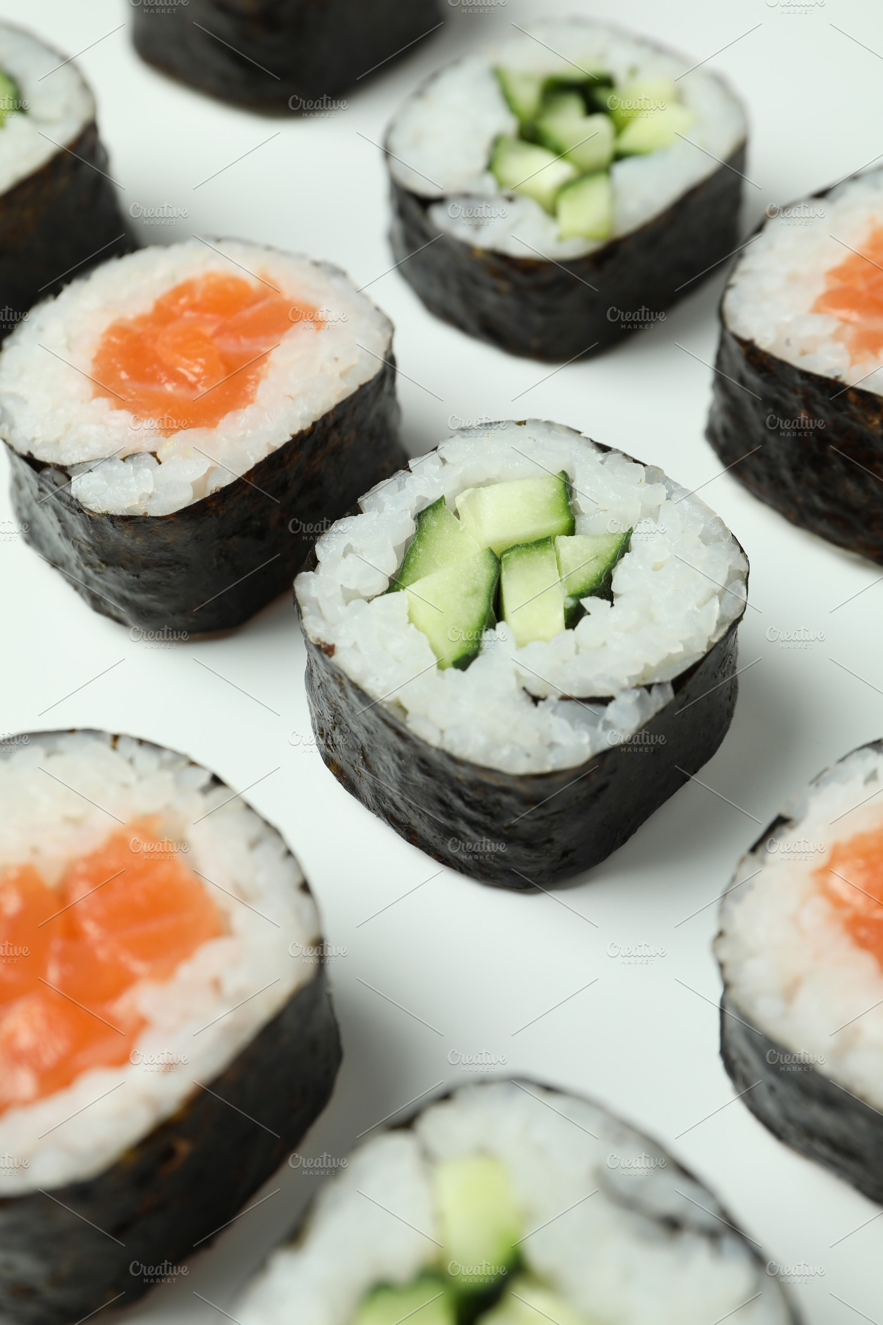 Concept of tasty food with sushi rolls on white background, a Food & Drink Photo by AtlasStudio PRO
