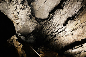 Mammoth Cave interior scene with dramatic lighting on rugged rock formations in, a Nature Photo by AS photostudio