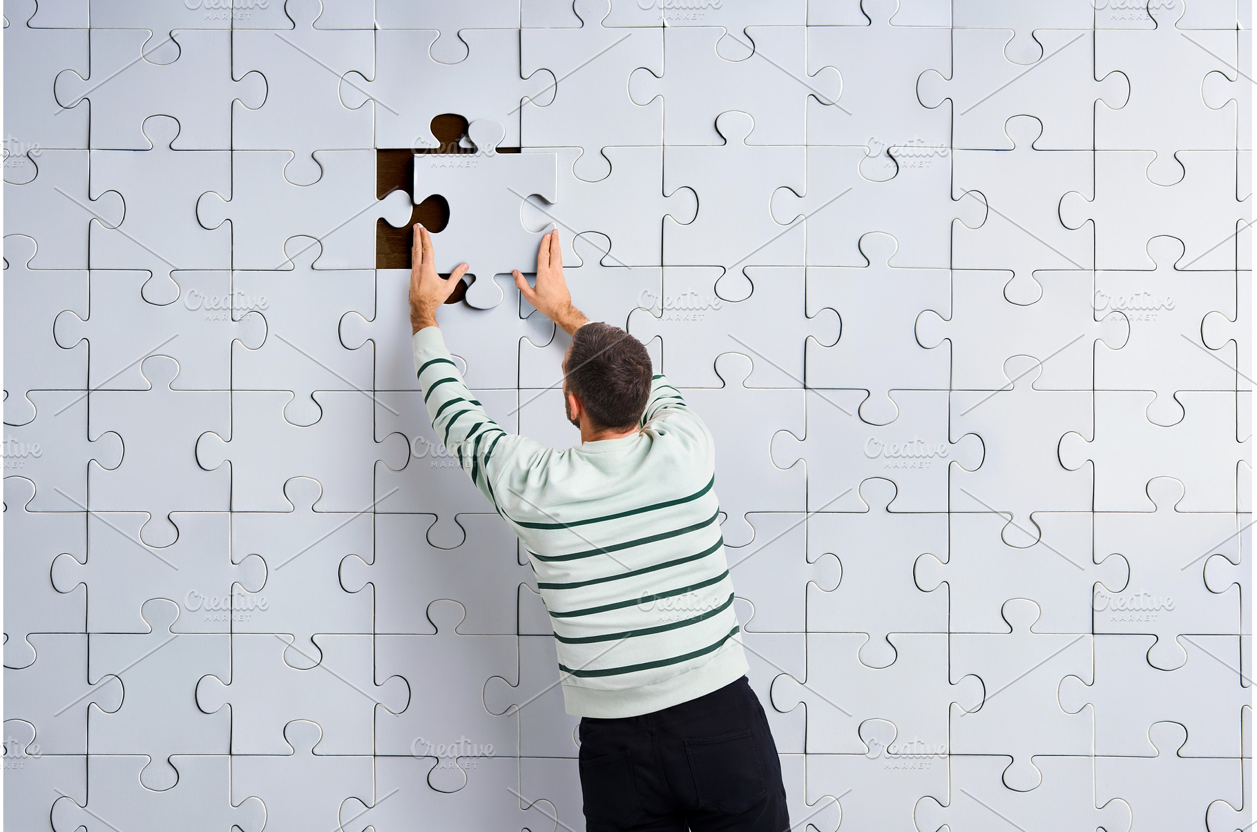 Rear view of man placing the final, a Business Photo by Gladkov photography
