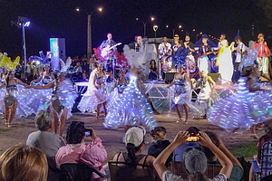 Audience watching outdoor performance at night, an Architecture Photo by DanFLCreativo
