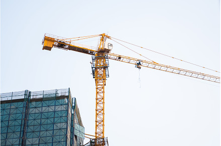 Yellow tower crane rising above
