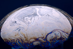 Vibrant abstract swirl pattern with blue, white, and gold tones,, a Background Photo by Ales Munt