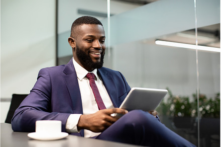 Cheerful black businessman using, a Person Photo by Prostock-Studio
