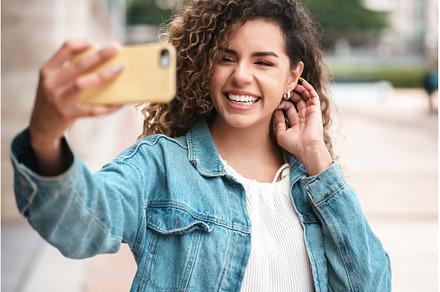 Young woman taking selfies with her, a Person Photo by Mego-studio