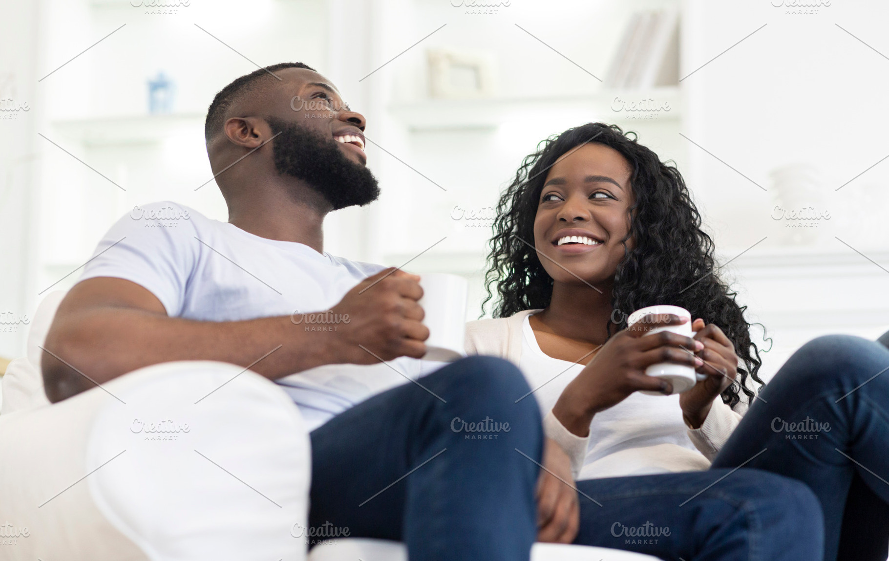 Cheerful black couple relaxing with, a Photo by Prostock-Studio ...