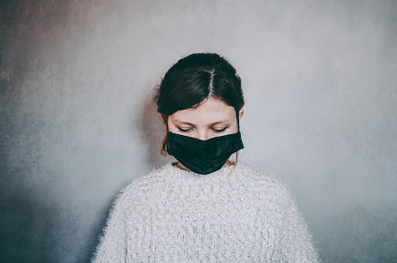 Young woman wearing a black face mask, a Person Photo by NanihtaCreative