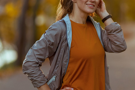 smiling fit woman in fitness clothes in park relaxing, a Sports & Recreation Photo by Alliance Images