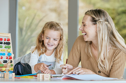 Math, school work and family learning education, comic conversation while studying in books and happy with student at table in home. Mother and girl doing homework for knowledge at desk in house, a Photo by Peopleimages.com