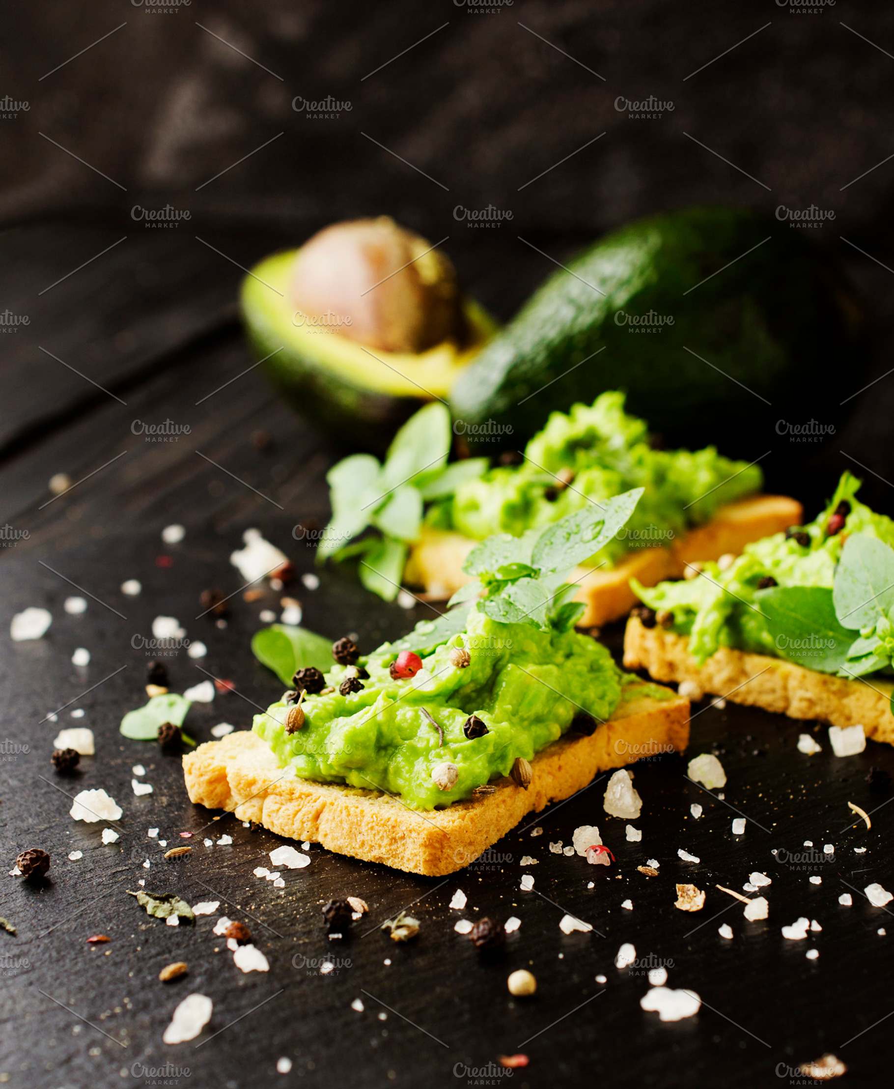 Toast with a paste of avocado and pesto basil spices containing avocado, a Food & Drink Photo by Wild Drago Shop