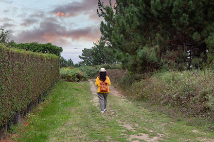 Adult woman with a leather backpack walks down, a Person Photo by José Manuel Gelpi