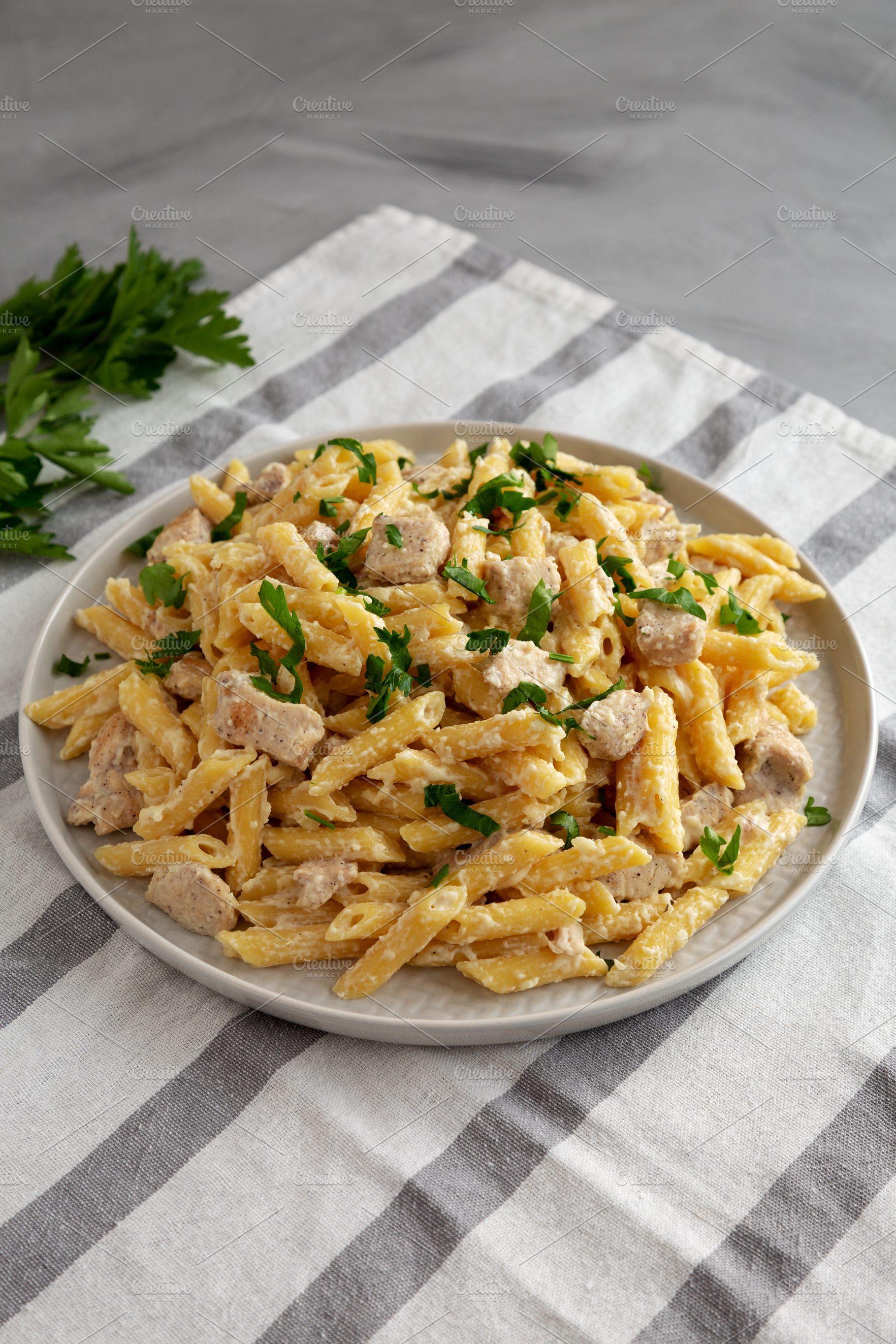 Homemade One-Pot Chicken Alfredo Pasta with Parsley on a Plate,, a Photo by LiudmylaChuhunova