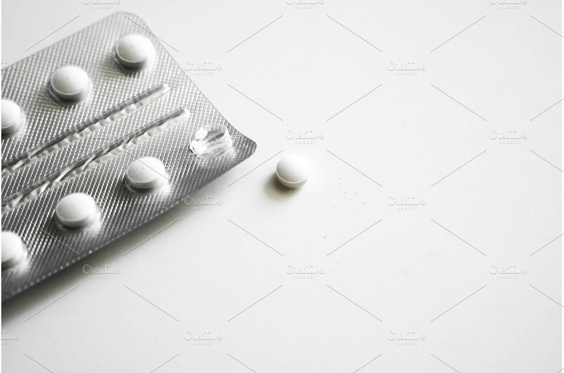 White round tablets scattered on, a Health & Medical Photo by volodymyrshtun13795
