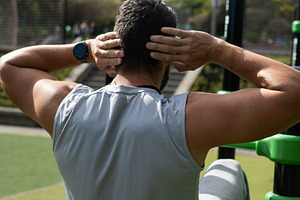 Young athletic man doing sit-ups exercise outdoors in park, a Food & Drink Photo by etorres69
