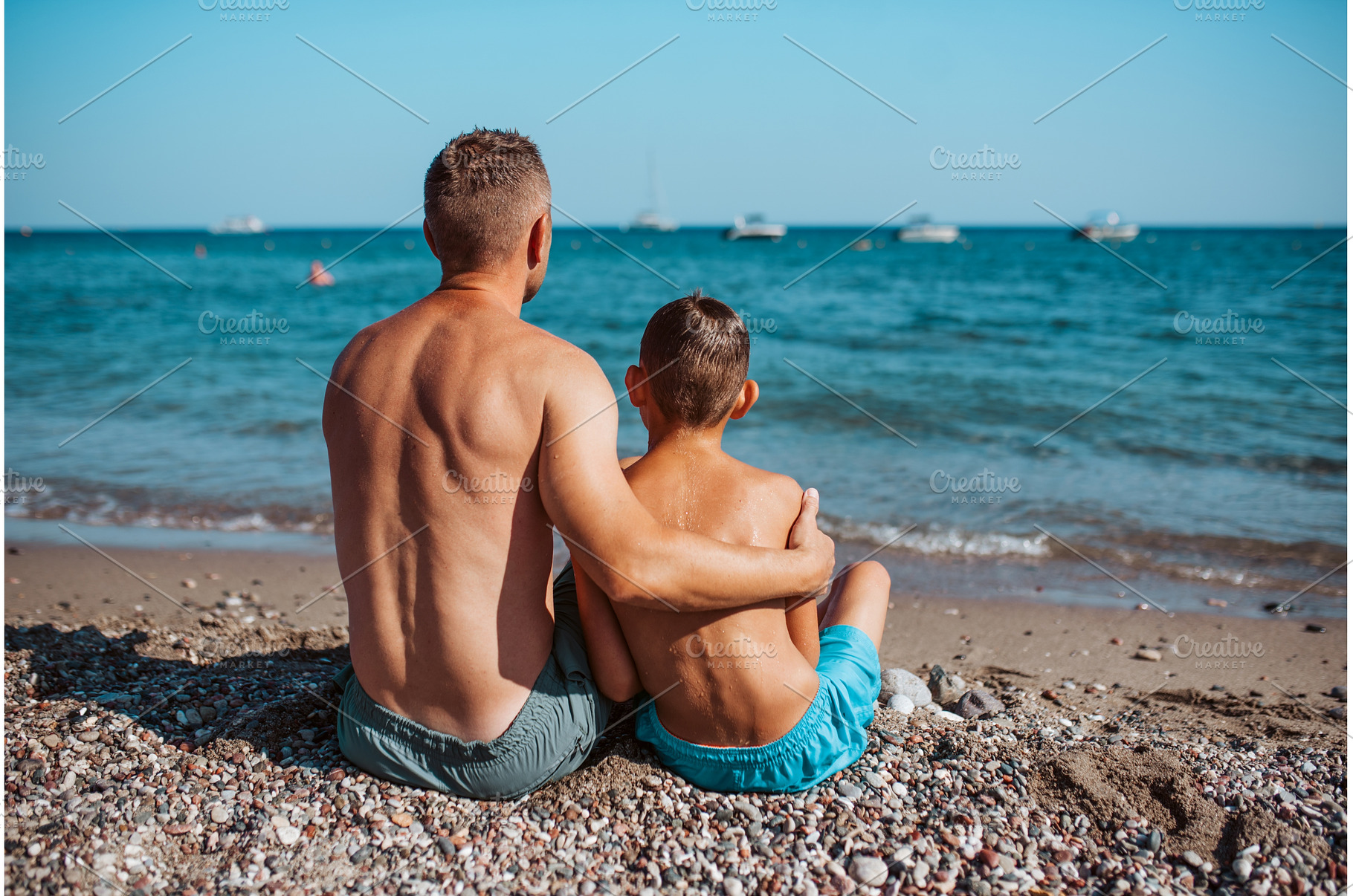 Rear view of son and father looking, a Sports & Recreation Photo by HalfPoint