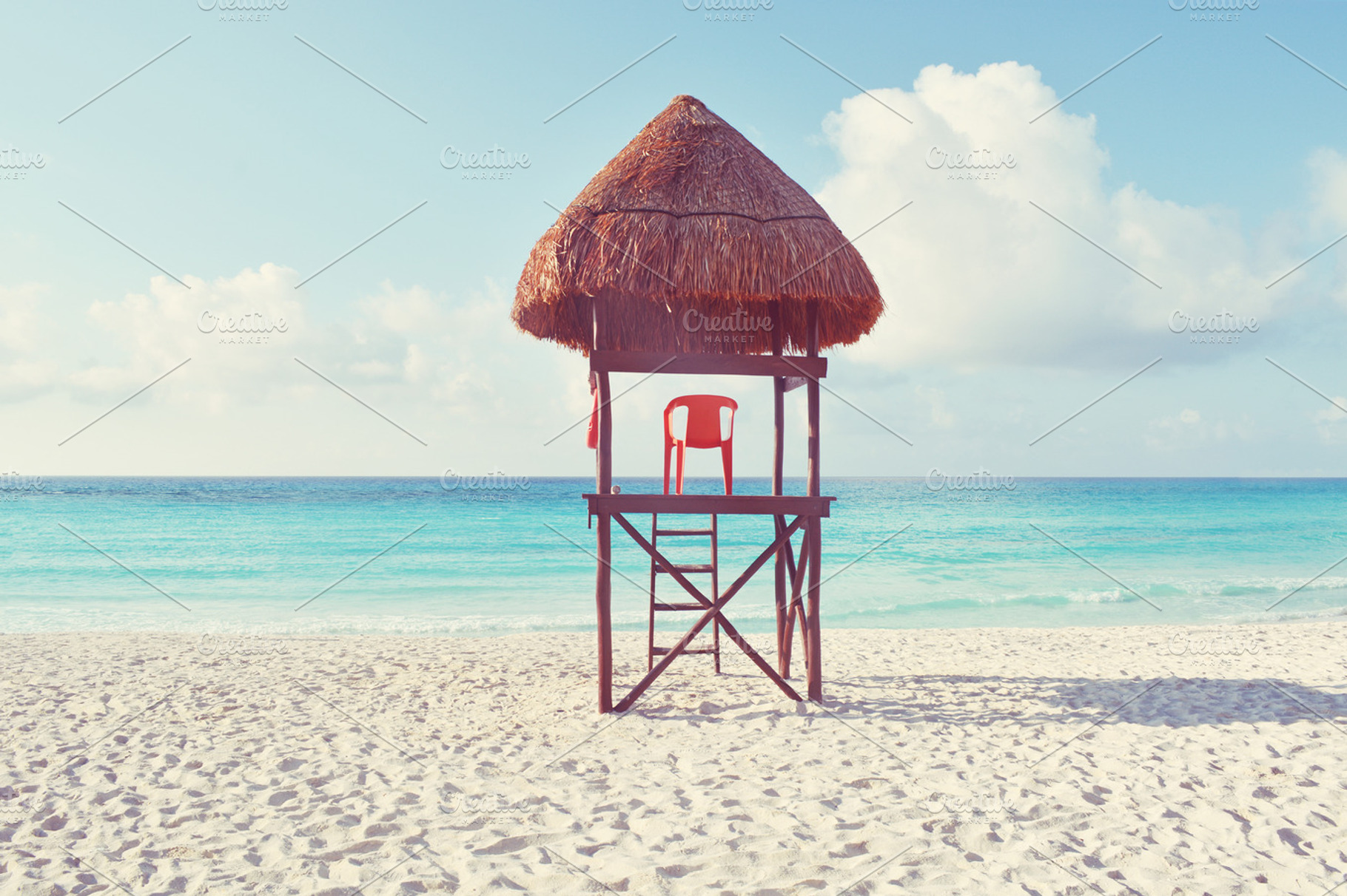 Lifeguard chair containing lifeguard, chair, and beach