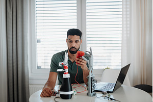 Engineer testing robotic arm, a Technology Photo by HalfPoint