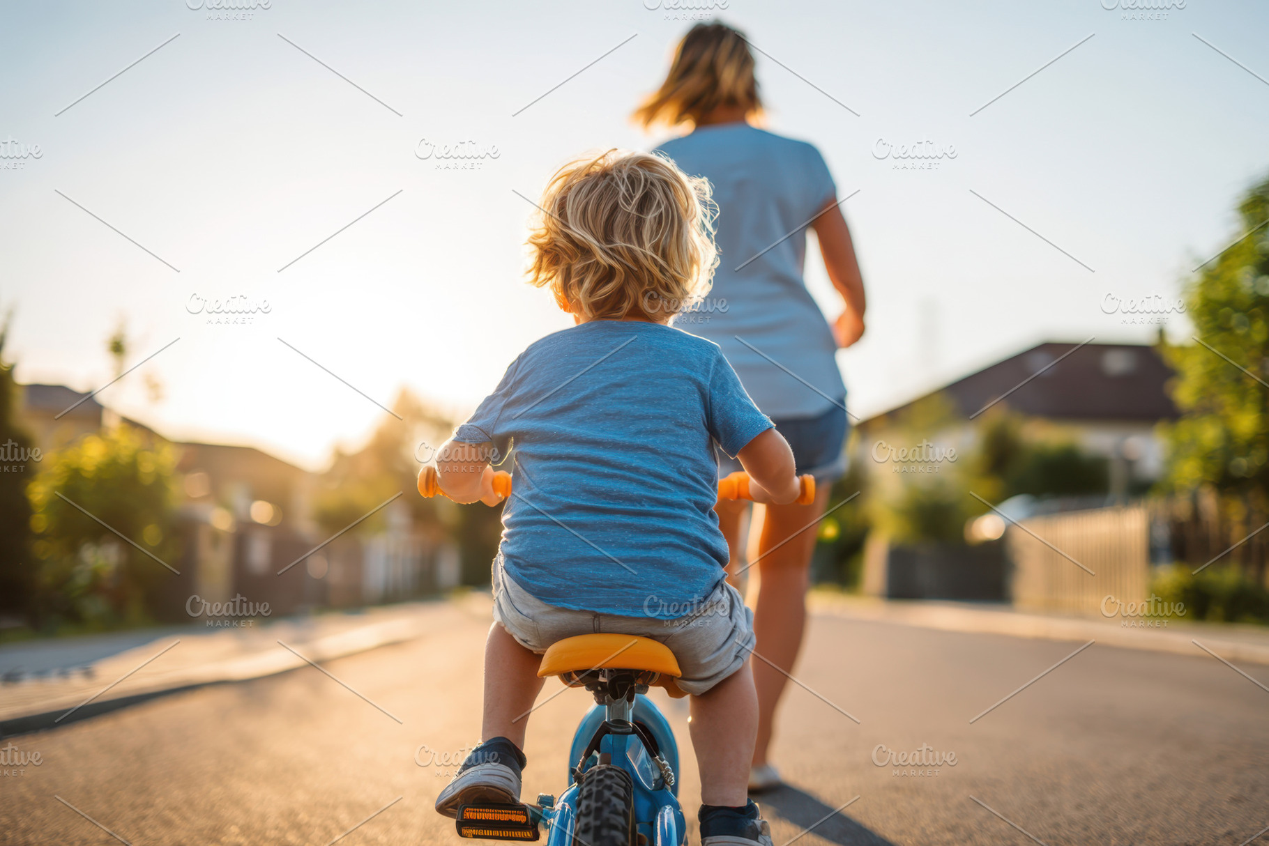 Child riding tricycle with woman jogging in background, a Person Photo by AlyaAnd