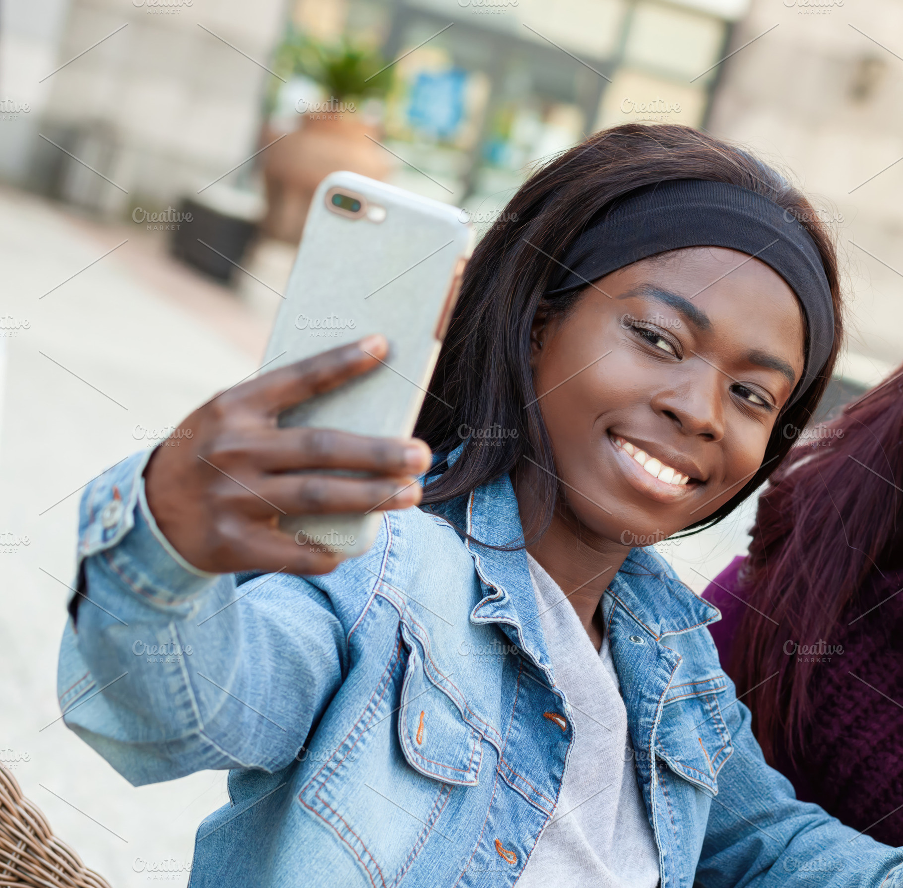 Young african american woman taking a selfie with smartphone, an Abstract Photo by Antonio Gravante Market