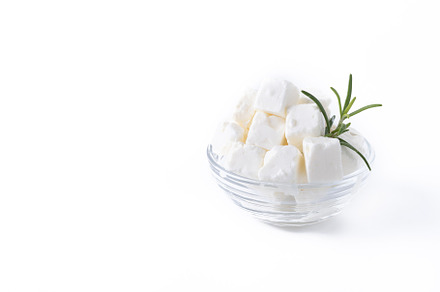 Feta cheese, cucumber and herbs in a bowl isolated on white back, a Food & Drink Photo by etorres69
