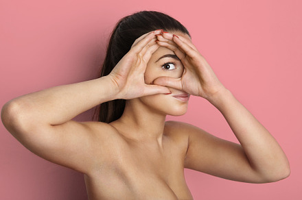 Portrait of beautiful young female containing face, brunette, and hand