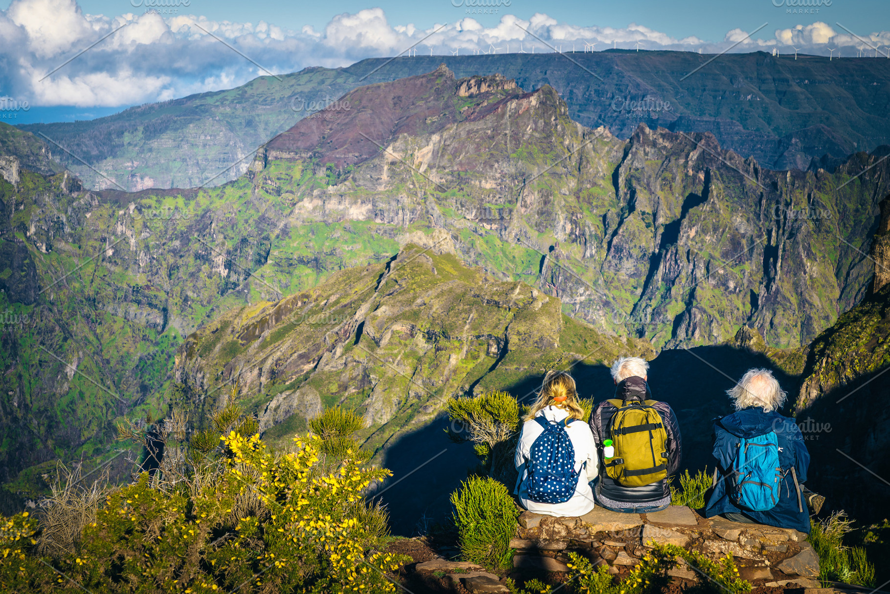 Older friends sitting in mountains, a Sports & Recreation Photo by Alpine Dreams