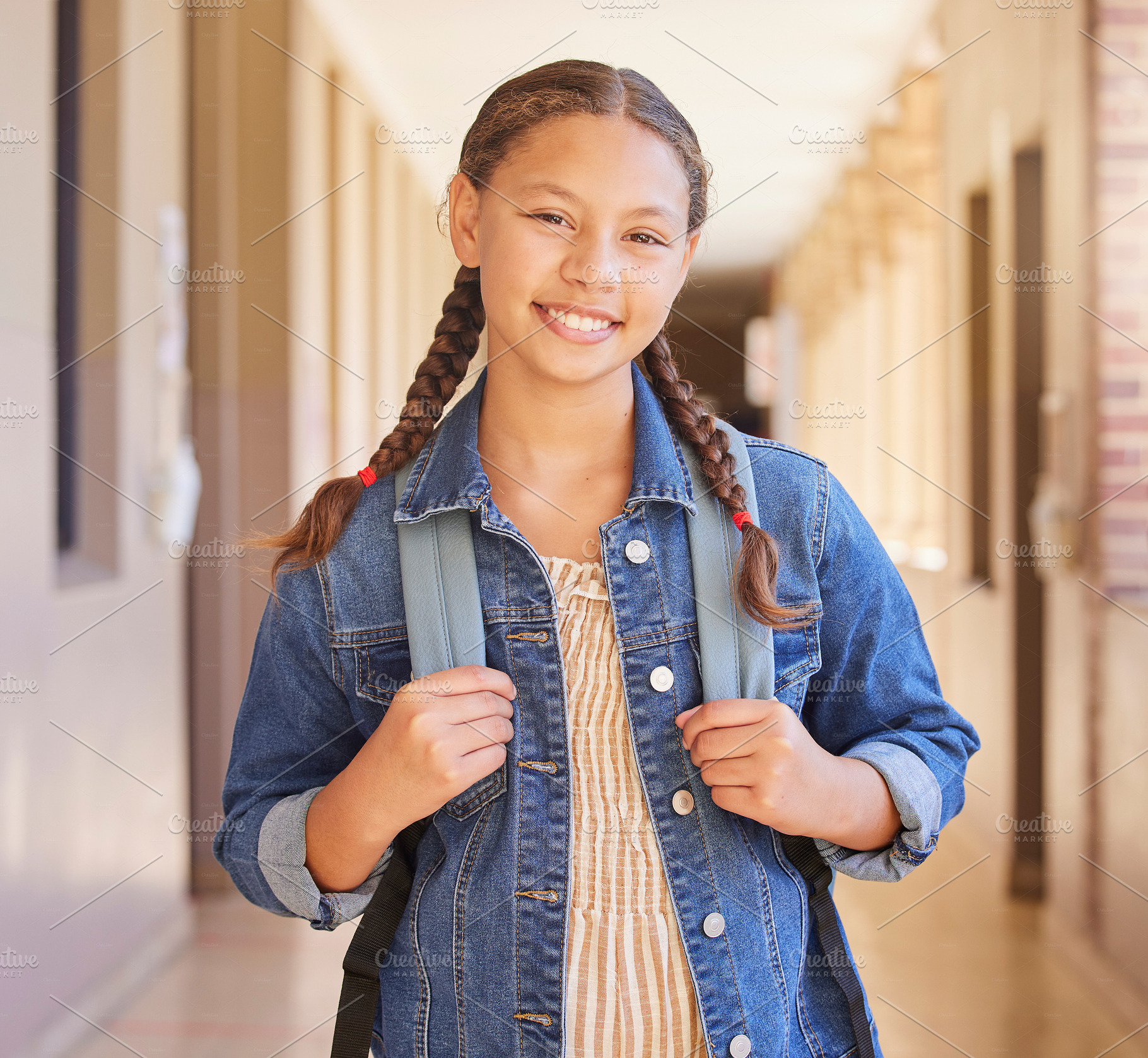 School, Backpack and portrait of girl student with education to learn, study and have knowledge. Happy, smile and child standing in the hallway or aisle with her bag for class in a high school campus, a Photo by Peopleimages.com