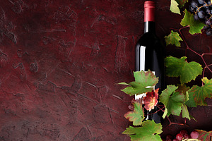 Red Wine Bottle with Grapes and Vine Leaves on Rustic Background, a Food & Drink Photo by Natalia Klenova's Shop