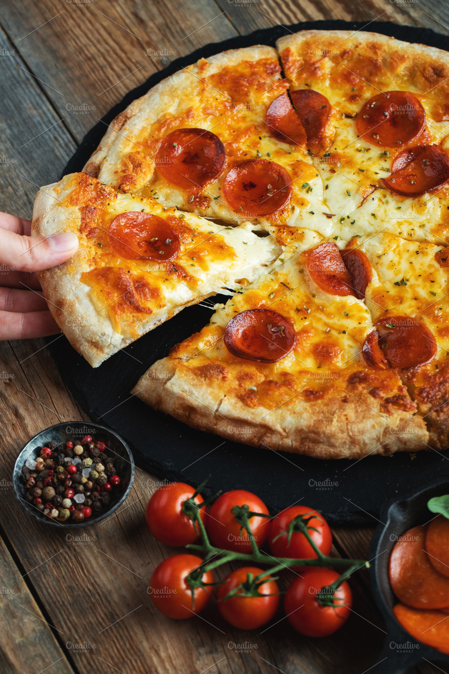 A slice of hot Italian pizza with stretching cheese. Pizza pepperoni on a dark, a Food & Drink Photo by Budarinphoto