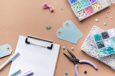 Crafting supplies arranged on a workspace with beads, tools,  ta, an Arts & Entertainment Photo by Olena Rudo
