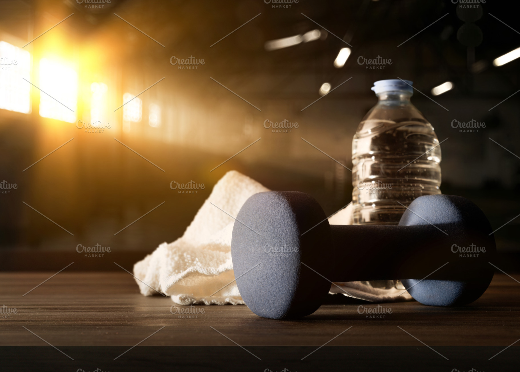 Sport training with dumbbell on wooden bench and gym background, a Sports & Recreation Photo by Davizro's Market