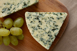 Delicious Cheese Danablu on a wooden board, top view. Close-up., a Food & Drink Photo by LiudmylaChuhunova