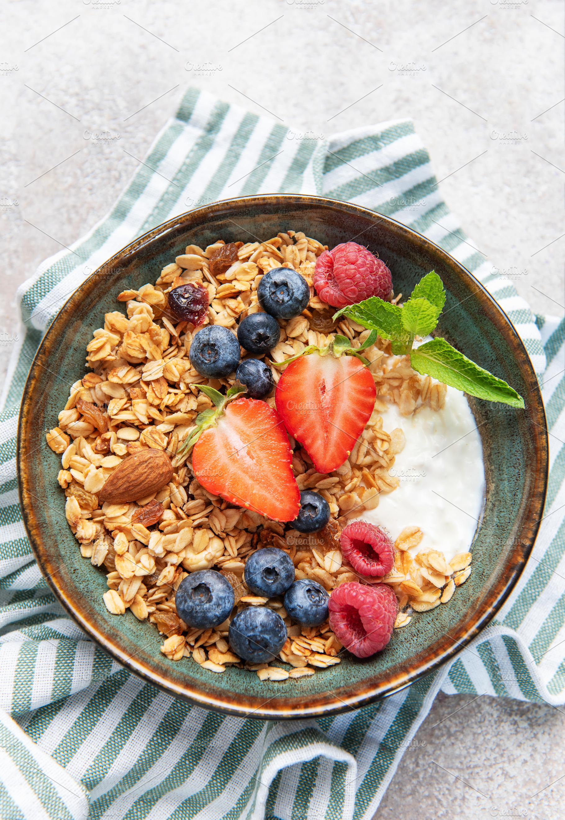 Granola bowl with yogurt, berries, and mint, a Food & Drink Photo by Olena Rudo