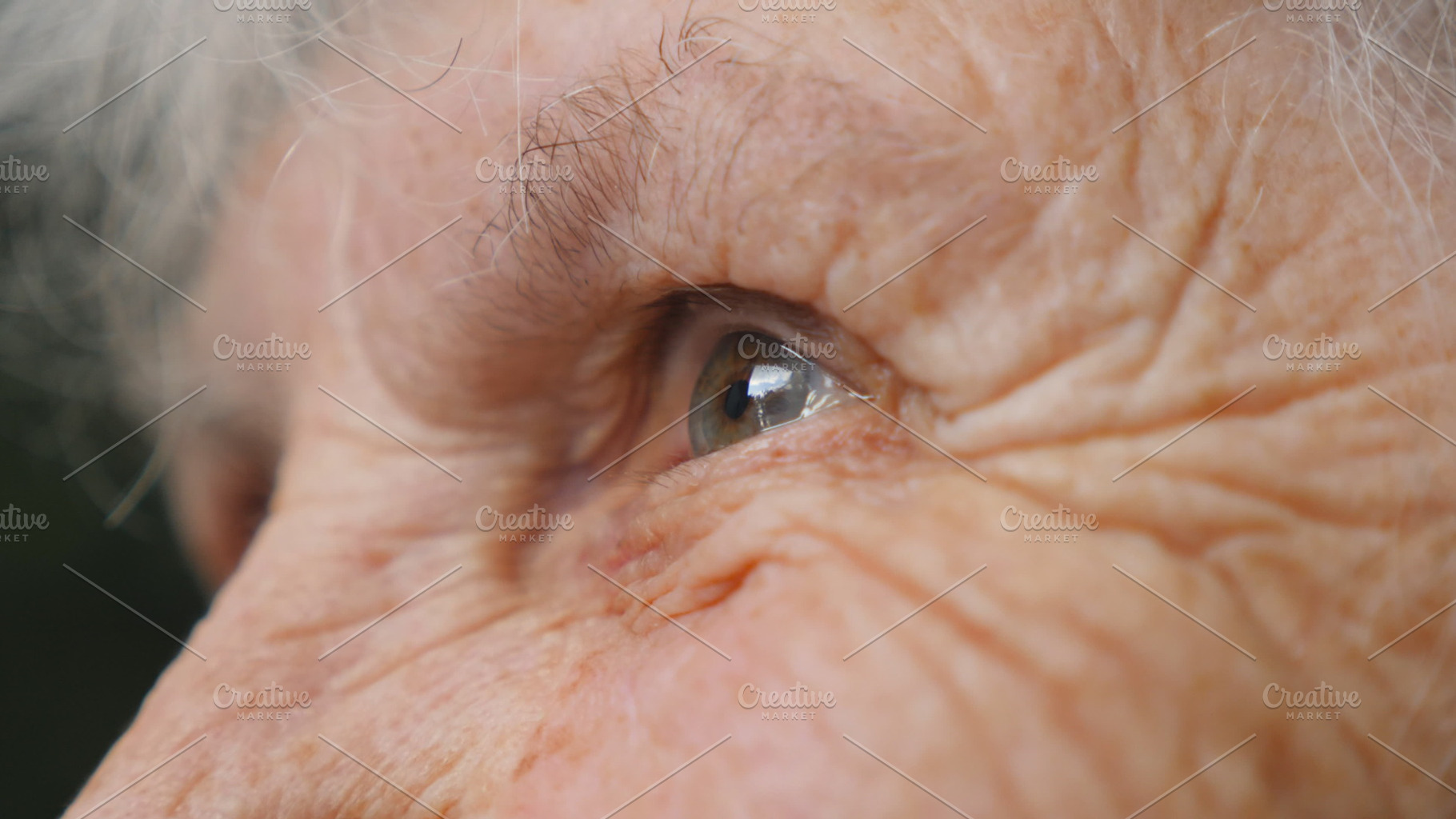 Old woman looking into the distance and smiling. Portrait of happy grandmother. Close up Side view Slow motion, a Person Photo by Footage Autor