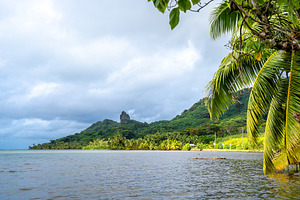 Maroe Bay with lush hills and calm waters in Huahine, French Pol, a Nature Photo by GoodGoods