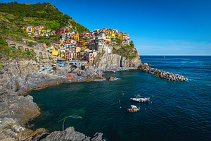 Anchored boats in the bay, Manarola, an Architecture Photo by Alpine Dreams