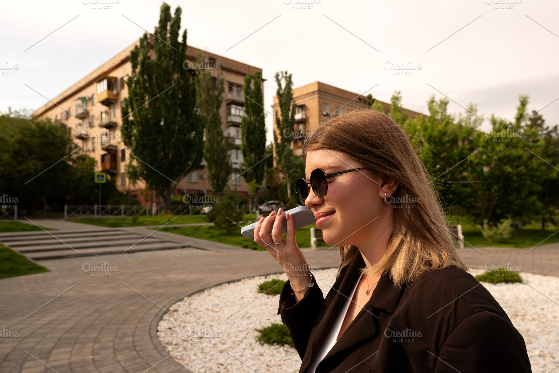 Woman using smartphone outdoors in r, a Person Photo by Elena Vagengeim