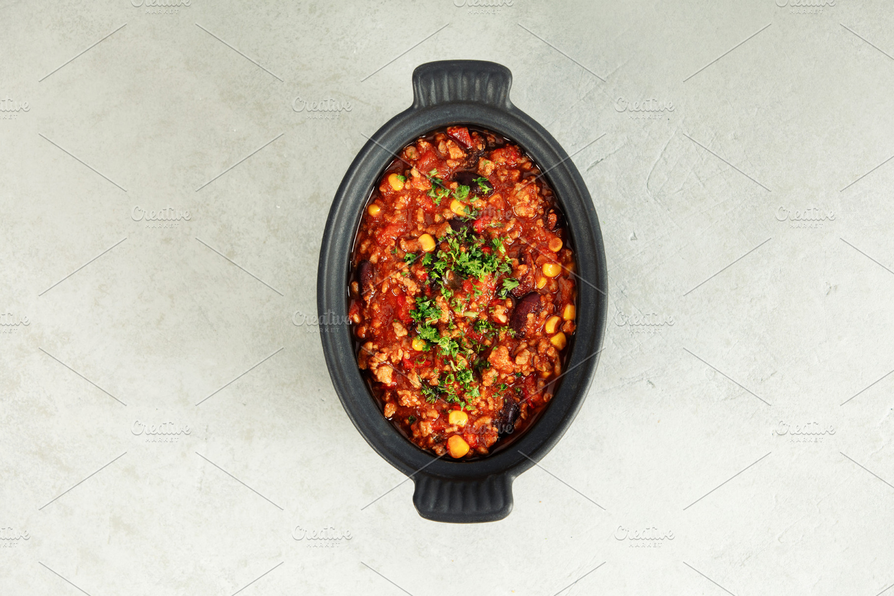 Traditional Mexican chili stew with vegetables in black bowl, a Food & Drink Photo by Natalia Klenova's Shop