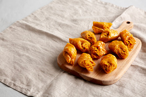 Sweet Homemade Turkish Baklava with Honey on a Wooden Board, sid, a Food & Drink Photo by LiudmylaChuhunova
