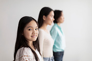 Cheerful little Asian girl with her mother and grandmother posing on white stud, a Photo by Prostock-Studio (Thumbnail 2 of 2)