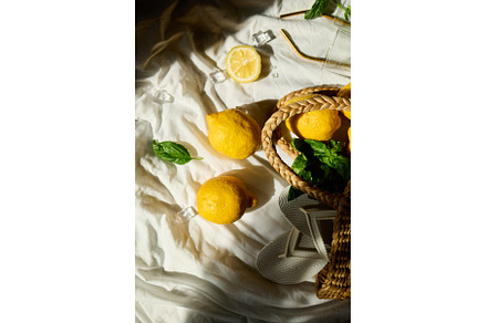 Bright summer lemons in a woven bag