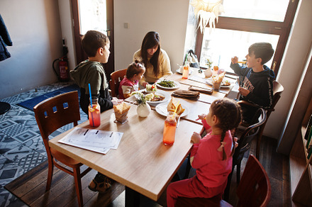 Mother with four kids spending time in cafe. Family lunch in the, a Person Photo by AS photostudio