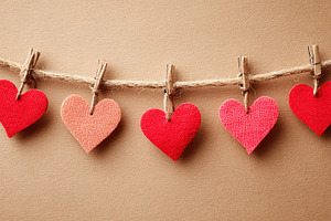 Colorful paper hearts hanging on twine, a Holiday Photo by AlyaAnd