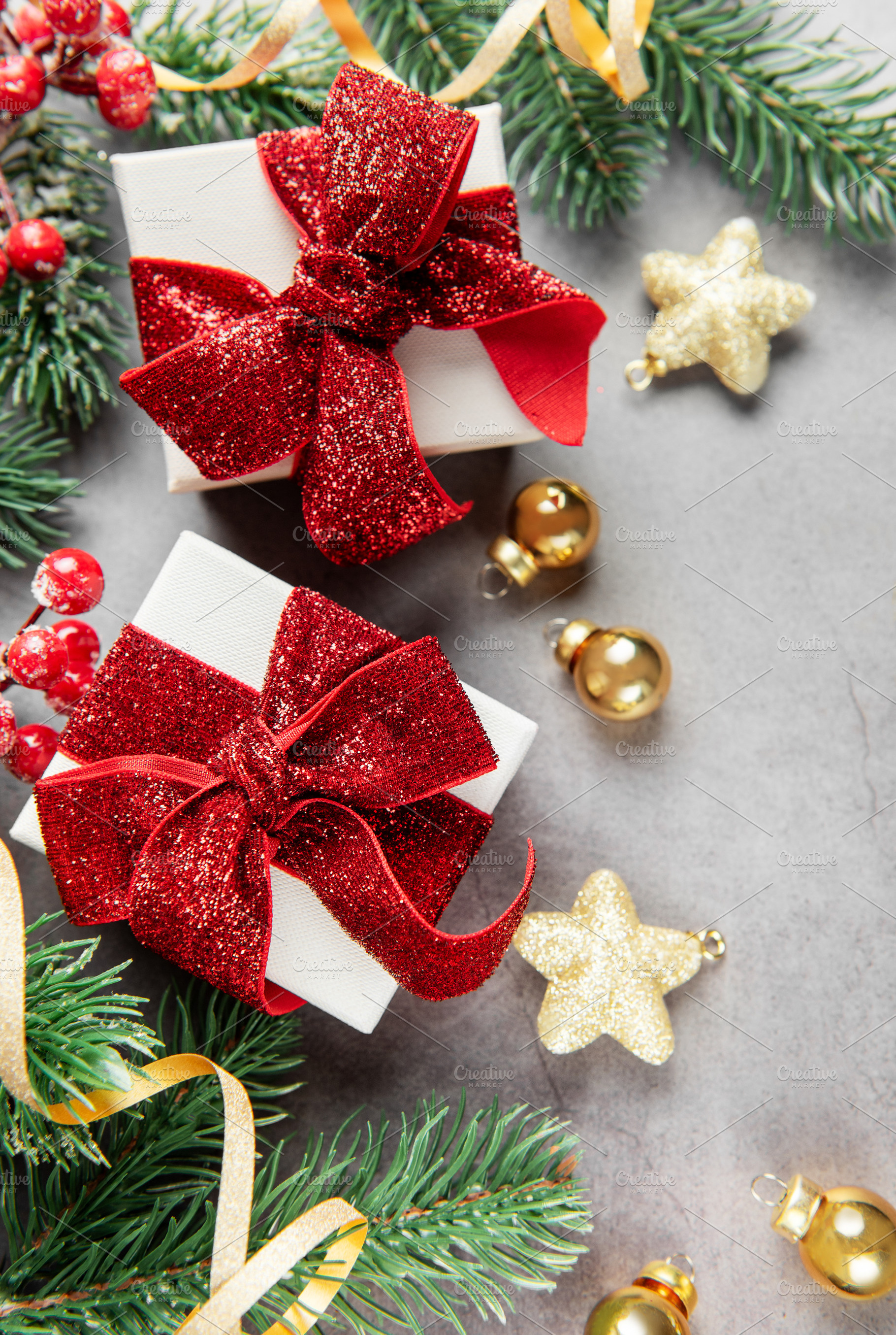 Christmas presents with festive decorations on gray background, a Holiday Photo by Olena Rudo