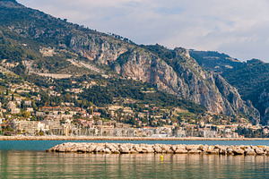 View of ligurian alps and menton city from the mediterranean sea stock photo, an Architecture Photo by Leonid Andronov