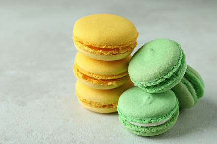 Concept of tasty dessert with macaroons on white textured backgr, a Food & Drink Photo by AtlasStudio PRO
