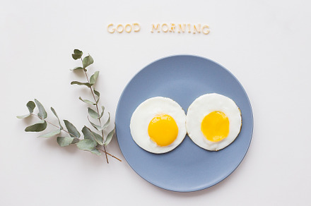 two beautiful eggs on a plate, a Food & Drink Photo by Artsaba Family