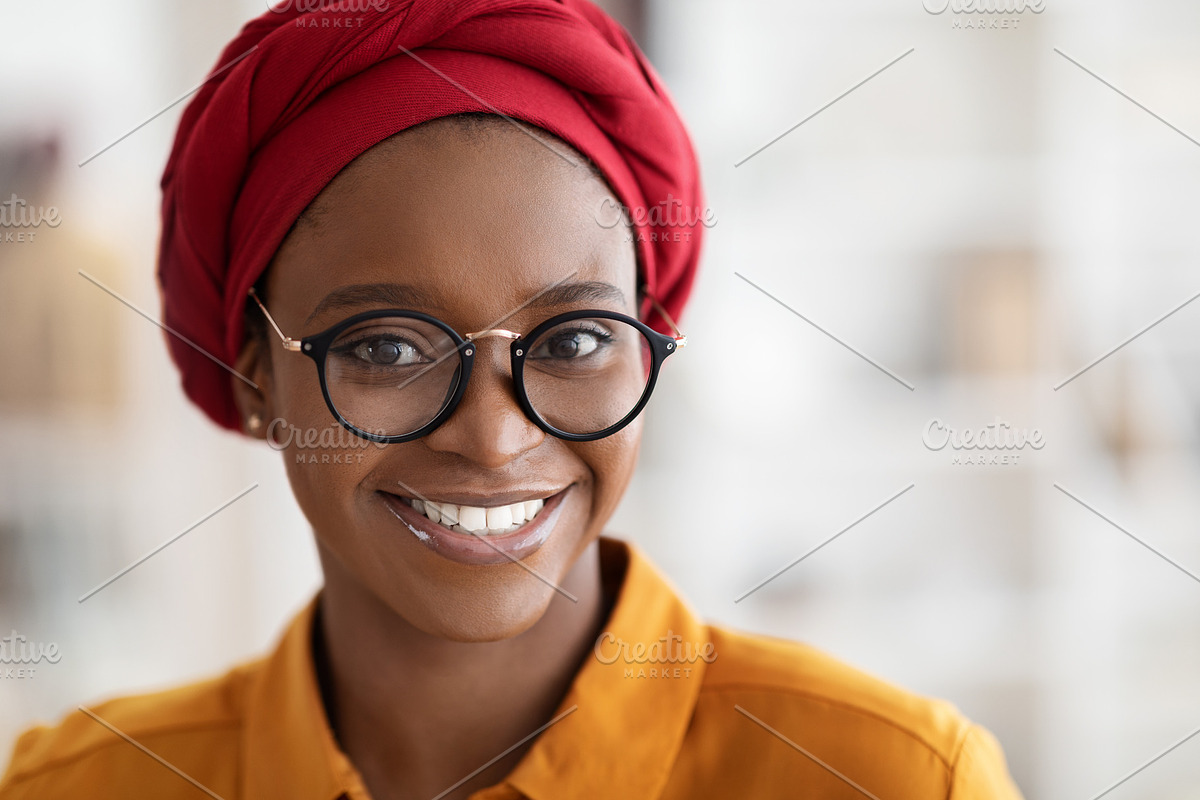 Closeup portrait of pretty young black lady wearing red headscarf, a Photo by Prostock-Studio (Photo 1 of 2)