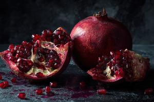 Pomegranate cut open on a table, a Photo by Beautiful things